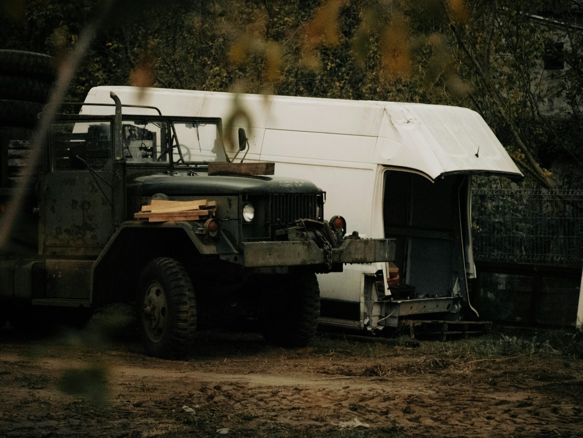 a military truck parked in front of a tent